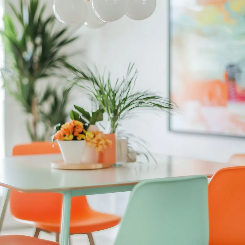 Bright dining corner with orange and mint accents